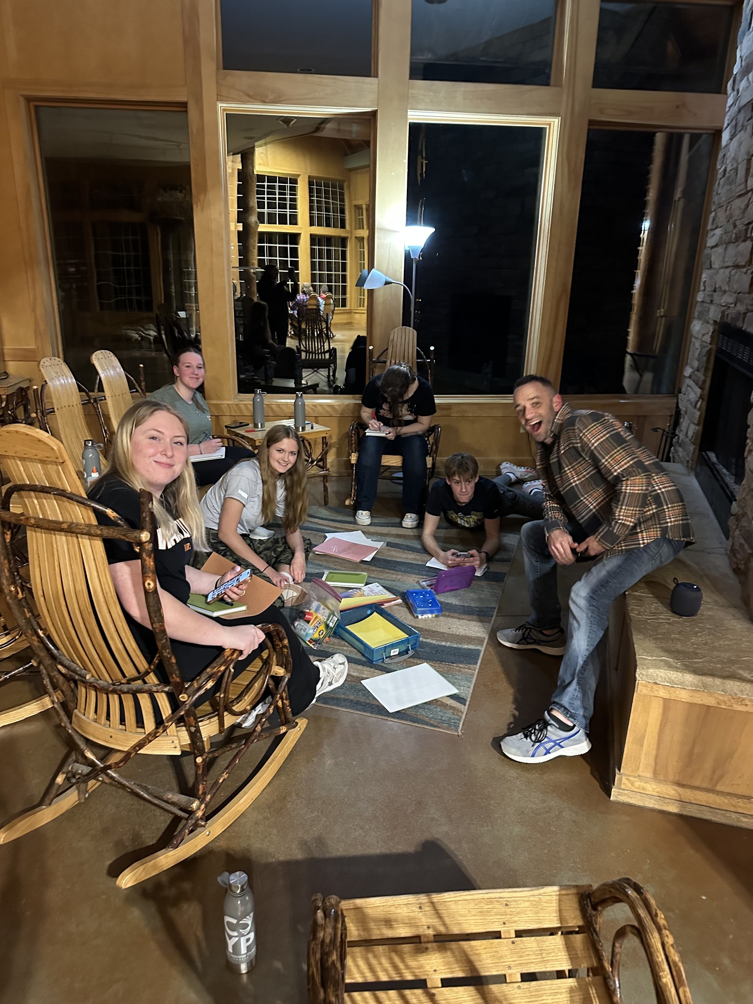 State Teen Panel members gathered by a fireplace during the STP Retreat