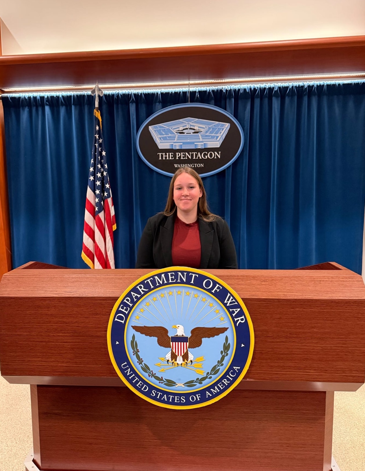 Charlee Cromwell at the Pentagon briefing podium in Washington, D.C.