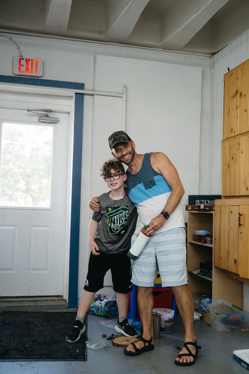 Joseph smiling with mentor Chris inside the rec hall