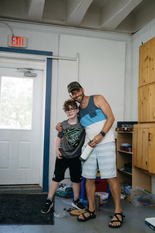 Joseph smiling with mentor Chris inside the rec hall