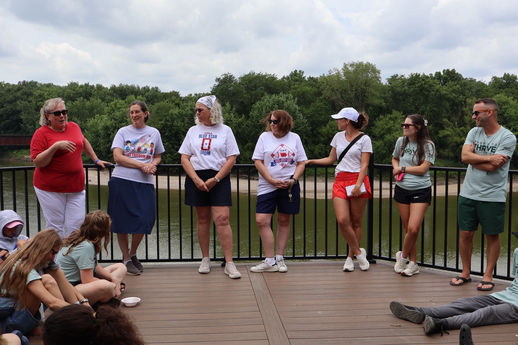 Community guests and camp leaders speaking with youth during an ice cream gathering