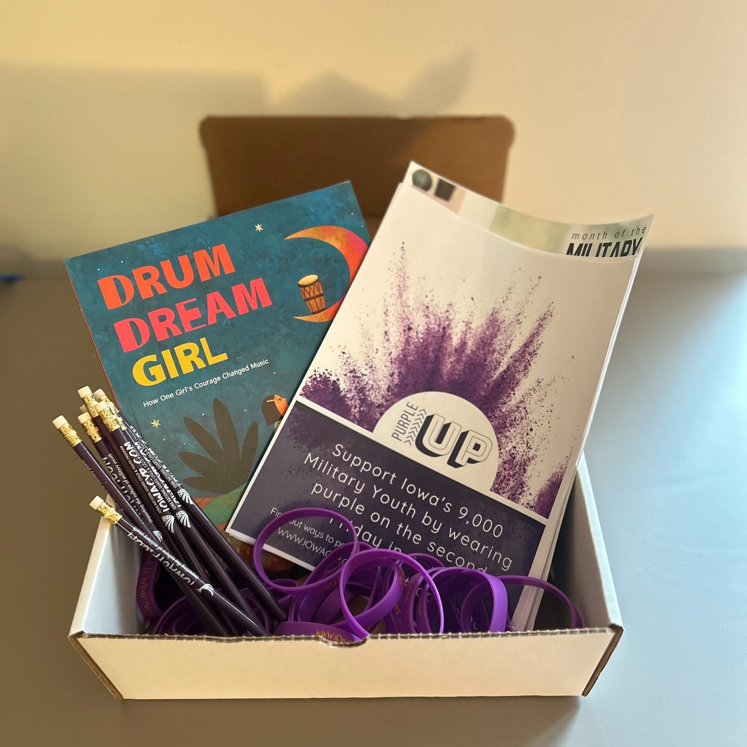 Students opening Purple Up classroom kits filled with activities