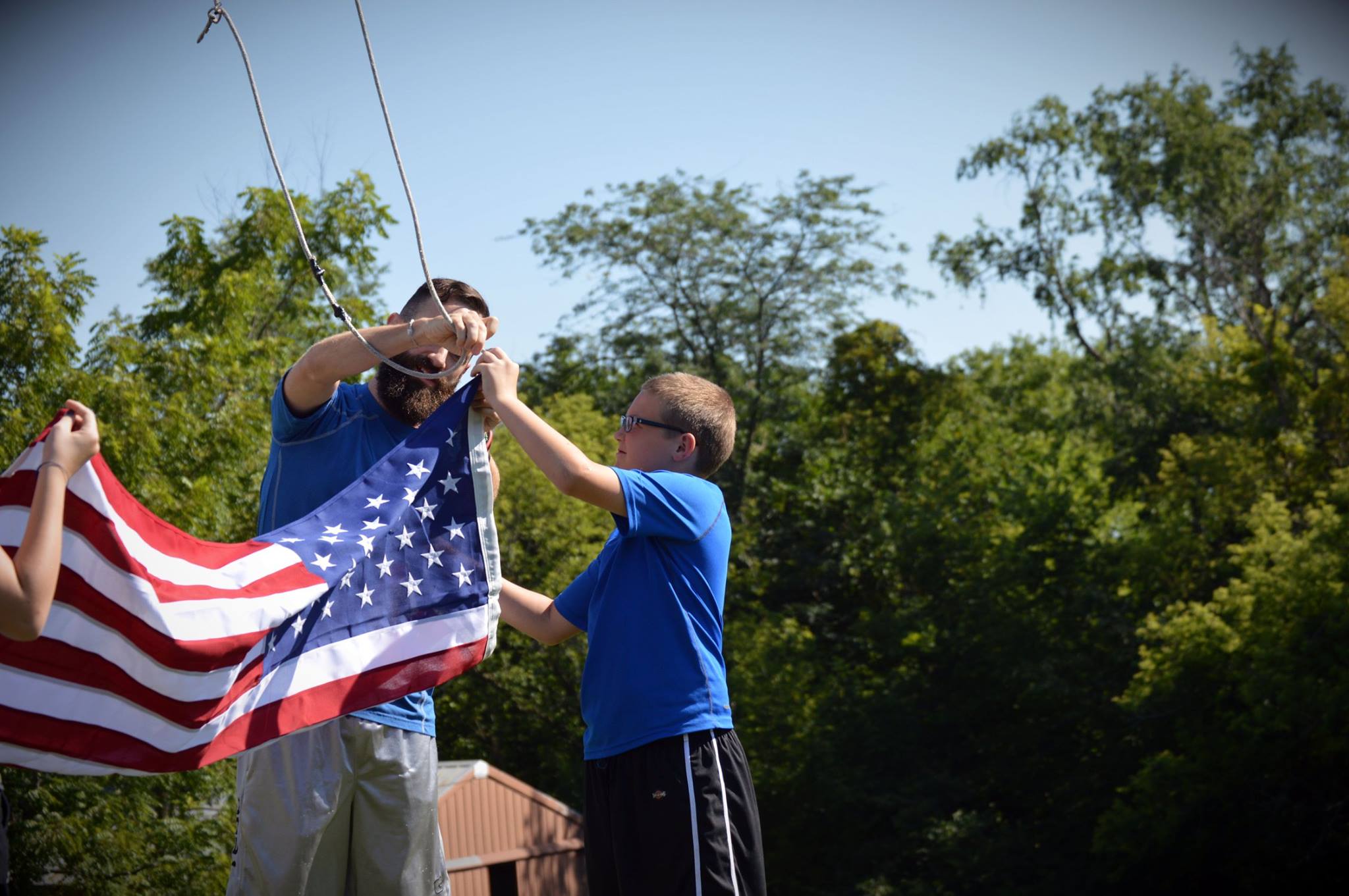 Guard-connected youth and families gathered with patriotic bunting